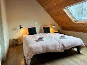 a bedroom with a large bed with a window at Spacious Design Home with Garden near Centre in Bruges