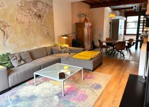 a living room with a couch and a table at Spacious Design Home with Garden near Centre in Bruges