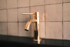 a bathroom sink with a faucet on a counter at Vakantiehuis ABEL in Dilsen-Stokkem
