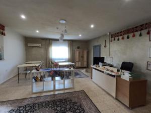 a living room with a counter and a table with shoes at B&B petrafarmhouse in Wadi Musa