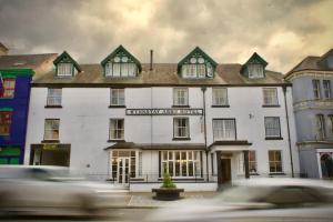 a car driving past a white building at The Wynnstay in Machynlleth +56 photos