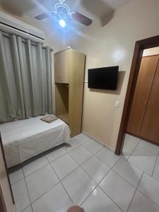 a room with a bed and a tv in it at Golden Hotel Ltda - Próximo a DPM, Aeroporto, Rodoviaria Porto Alegre, Arena do Grêmio in Porto Alegre