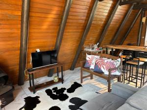 een woonkamer met een bank en een koeienhuid bij Chalé Sossegado in Treviso