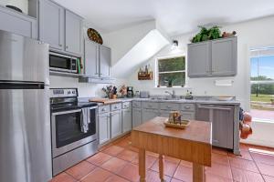 a kitchen with stainless steel appliances and a wooden table at Mi Rancho in Wimberley