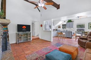 a living room with a couch and a ceiling fan at Mi Rancho in Wimberley +31 photos