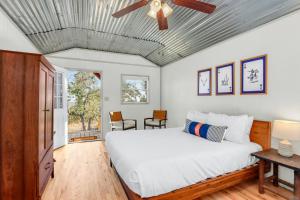 a bedroom with a bed and a ceiling fan at Daybreak Ridge Entire Property in Blanco