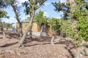a house in the woods with trees at Daybreak Ridge Entire Property in Blanco +37 photos