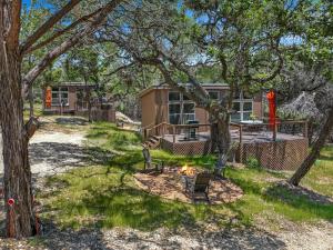 a home with a fire pit in the yard at Martha at the Bend in Wimberley