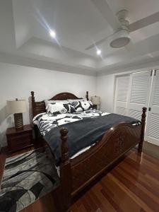 a bedroom with a bed with a black and white comforter at Villa Ray in Gros Islet +58 photos
