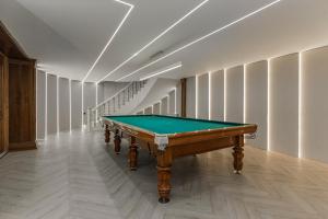 a pool table in a hallway with a staircase at Ermensai Wellness Boutique Hotel in Almaty +117 photos