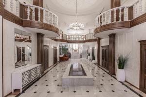 a large hallway with a fountain in the middle of a building at Ermensai Wellness Boutique Hotel in Almaty