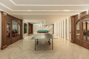 a ping pong table in the middle of a room at Ermensai Wellness Boutique Hotel in Almaty