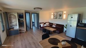 a living room with a couch and a table at Cozy Box in Agapia