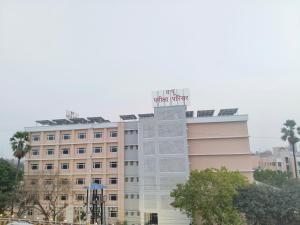 a building with a sign on top of it at Rupali Guest House in Patna
