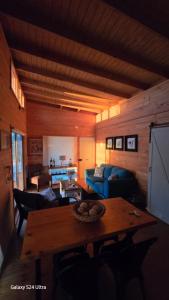 a living room with a table and a blue couch at Romantic Getaway Peace and a Unique View in Quillota