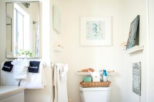 a bathroom with a toilet with towels and a mirror at Cambria Mountain View Retreat in Cambria +21 photos