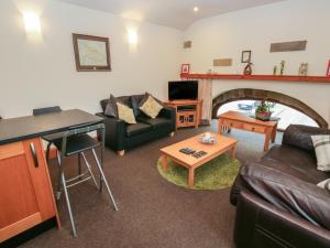 a living room with a couch and a fireplace at Green Route Apartment in Todmorden