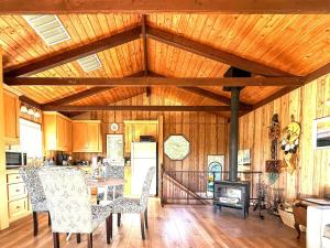 a kitchen with wooden walls and a table and chairs at Cambria Mountain View Retreat in Cambria