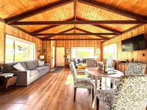 a living room with a couch and a table at Cambria Mountain View Retreat in Cambria