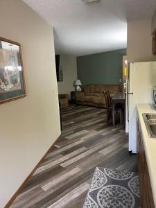 a living room with a couch and a table at Forrest Inn in Amery +31 photos
