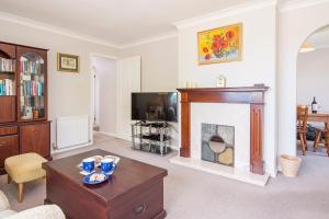 a living room with a fireplace and a tv at The Willows Dinas Cross in Newport