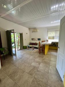 a living room with a table and a couch at Cabanas Los Colibris Hotel Ecolodge in San Carlos