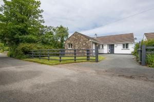 a house with a fence in front of it at The Willows Dinas Cross in Newport
