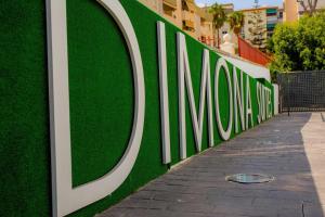 a green wall with theania sign on a sidewalk at BLUESEA Dimona Suites in Torremolinos
