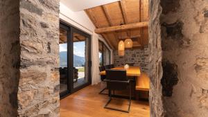 a dining room with a table and a large window at Villa Valentina by Rent All Como in Civenna
