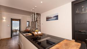 a kitchen with a black counter top and a sink at Villa Valentina by Rent All Como in Civenna
