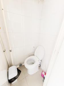 a bathroom with a toilet and a trash can at Studio La Gare in Paris