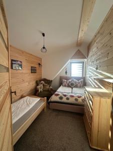 a bedroom with a bed and a couch in a room at U Borowiczów in Białka Tatrzańska