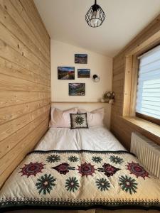 a bedroom with a bed with a quilt on it at U Borowiczów in Białka Tatrzańska