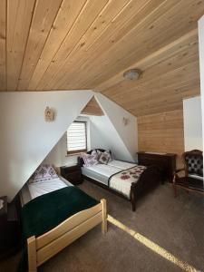 a bedroom with two beds in a attic at U Borowiczów in Białka Tatrzańska