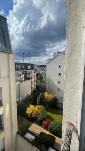 a view of a garden from a window of a building at Studio La Gare in Paris