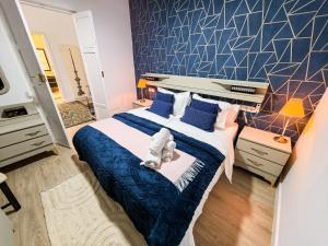 a bedroom with a large bed with a stuffed animal on it at Palacete BARSANZ HOME in Alcalá del Valle