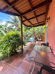 a patio with a table and chairs on it at Cabanas Los Colibris Hotel Ecolodge in San Carlos