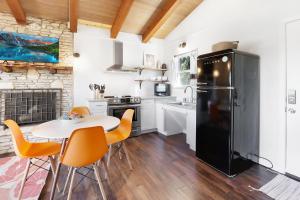 a kitchen with a table and a black refrigerator at Millies Cottages Unit 1 - Ruth in Canyon Lake