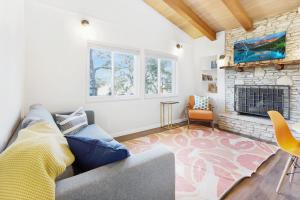 a living room with a couch and a fireplace at Millies Cottages Unit 1 - Ruth in Canyon Lake