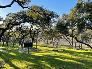 a park with trees and a mailbox in the grass at Millies Cottages Unit 1 - Ruth in Canyon Lake +9 photos