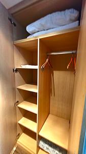 an open closet with shelves and a bed in it at Mihailo Konaci hotel Andjela in Kopaonik