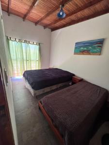 a bedroom with two beds and a window at Complejo del Mar in Santa Clara del Mar