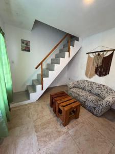 a living room with a couch and a staircase at Complejo del Mar in Santa Clara del Mar