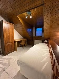ein Schlafzimmer mit einem Bett und einem Schreibtisch in einem Zimmer in der Unterkunft Hotel Monika in Zutendaal