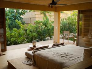 a bedroom with a large bed and a large window at Kymaia Hotel Puerto Escondido in Tlachicón +40 photos