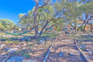 a hammock hanging from a tree in a field at Millies Cottages Unit 3 - Phyllis in Canyon Lake