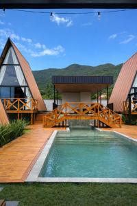 a view of a house with a bridge over a pool at Cabana Industrial in Palhoça