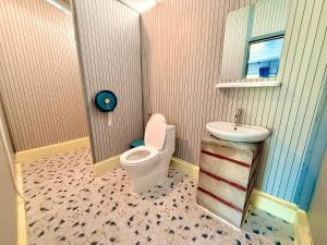 a bathroom with a toilet and a sink at Kohrong Central Beach in Koh Rong Island