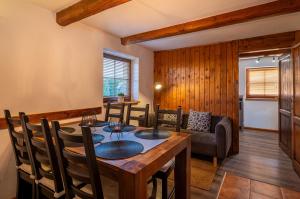 a dining room with a table and chairs and a couch at Chalupa Juraj Terchová in Terchová +5 photos