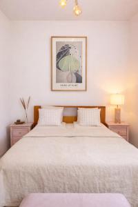 a bedroom with two beds and a picture of an umbrella at HaHa Nordic Home Partille Spacious 2BR Apartment near Center with Garden & Parking in Gothenburg